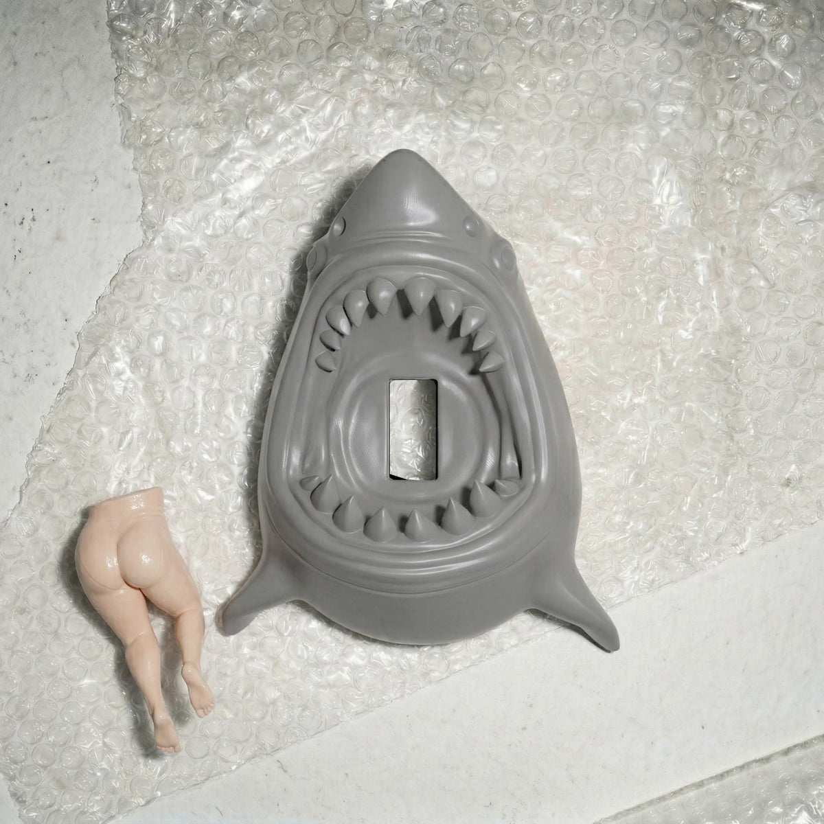 Bottoms Up shark switch cover on a wall